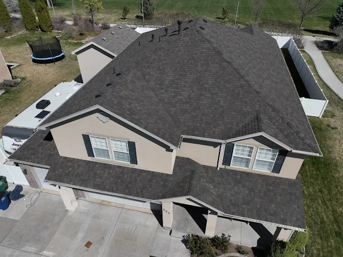 Aerial drone view of completed asphalt shingle roof replacement on a Utah home
