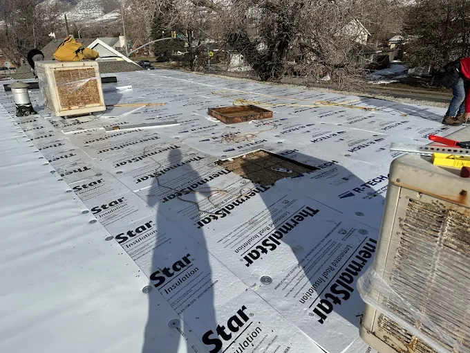 Commercial flat roof installation with insulation board on a Utah business property
