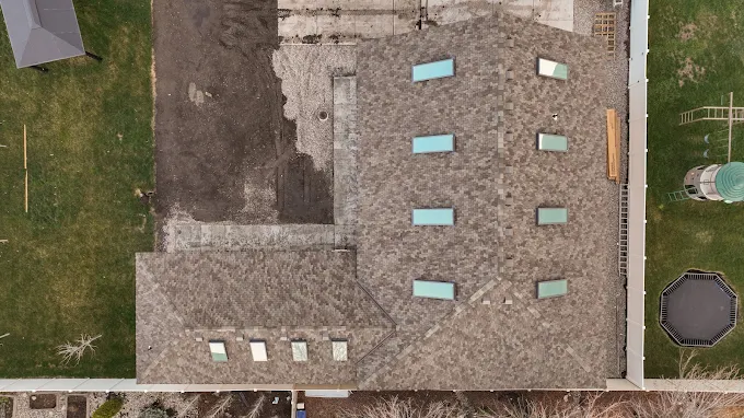 New construction roof with multiple skylights, aerial view